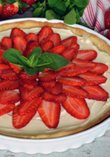 White chocolate mousse with fresh strawberries and mint leaves.